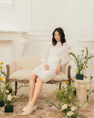 Organza knee-length dress with sheer puff sleeves and bow accents for feminine elegance