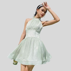 Sleeveless organza halter mini dress with tie-back detail and softly flared skirt