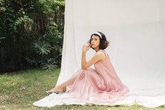 Sleeveless tiered midi dress in sheer organza with flowing silhouette and airy movement