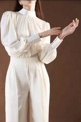 Silk blouse with high neckline, gathered bodice, and voluminous long sleeves