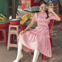 Silk midi dress with ruched bodice, puff sleeves, and flared tiered skirt