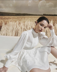 Mini silk dress with structured bodice, lantern sleeves, and flared pleated skirt