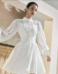 Mini silk dress with structured bodice, lantern sleeves, and flared pleated skirt