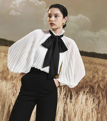 Sheer organza blouse with pleated bishop sleeves and oversized necktie bow detail
