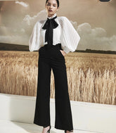 Sheer organza blouse with pleated bishop sleeves and oversized necktie bow detail