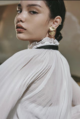 Sheer organza blouse with pleated bishop sleeves and oversized necktie bow detail