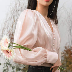 Fitted organza blouse with pearl button front and voluminous sheer puff sleeves