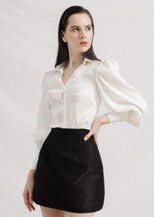 Silk mini skirt with tailored high waist and subtle textured weave for versatile styling