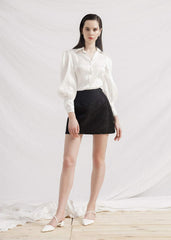 Silk mini skirt with tailored high waist and subtle textured weave for versatile styling