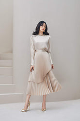 Pleated asymmetric midi skirt in flowing silk with layered hem and flattering silhouette
