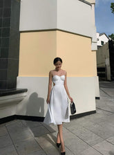 Silk dress with ruched bust detail and open back cutout design for elegant summer occasions