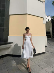 Silk dress with ruched bust detail and open back cutout design for elegant summer occasions