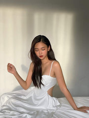 Silk dress with ruched bust detail and open back cutout design for elegant summer occasions