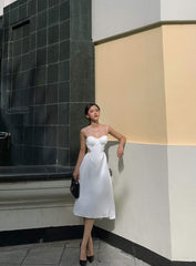 Silk dress with ruched bust detail and open back cutout design for elegant summer occasions