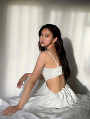 Silk dress with ruched bust detail and open back cutout design for elegant summer occasions