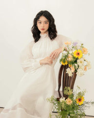 Organza midi dress with high smocked neckline and sheer bishop sleeves for refined elegance