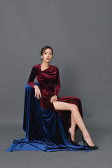 Velvet long-sleeve evening gown with draped neckline and high slit in floor-length silhouette