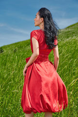 Silk midi dress with cinched waist and flutter sleeves in flowy silhouette for refined femininity