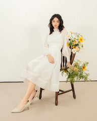 Organza midi dress with high smocked neckline and sheer bishop sleeves for refined elegance