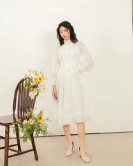 Organza midi dress with high smocked neckline and sheer bishop sleeves for refined elegance