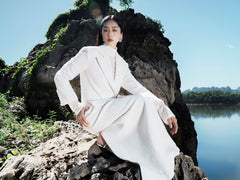 Textured wool-blend full-length coat with tailored notch lapels and adjustable waist tie