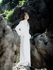 Textured wool-blend full-length coat with tailored notch lapels and adjustable waist tie