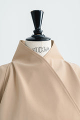 Tailored wool blend trench coat with oversized lapels and structured belted waist