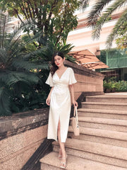 Silk midi dress with front slit and flutter sleeves, featuring button-down detailing