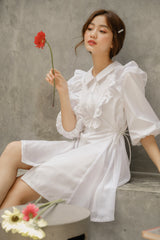 Silk dress with ruffled bib detail and puff sleeves in a structured A-line silhouette