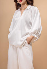 Relaxed-fit silk blouse with voluminous sleeves and open V-neckline for effortless elegance