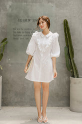 Silk dress with ruffled bib detail and puff sleeves in a structured A-line silhouette