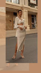 High-waisted silk midi skirt with side slits and sleek tailored silhouette for modern elegance
