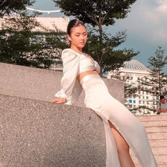 High-waisted silk midi skirt with side slit and smooth satin finish for evening elegance