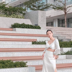 High-waisted silk midi skirt with side slit and smooth satin finish for evening elegance