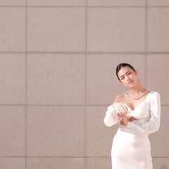 High-waisted silk midi skirt with side slit and smooth satin finish for evening elegance