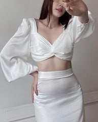 High-waisted silk midi skirt with side slit and figure-flattering tailored silhouette