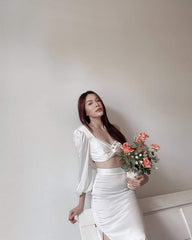 High-waisted silk midi skirt with side slit and figure-flattering tailored silhouette