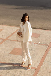 Tailored silk blazer with structured shoulders and draped open front for refined layering