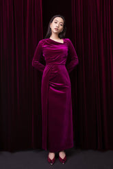 Velvet long-sleeve gown with draped neckline and cinched waist in floor-length silhouette