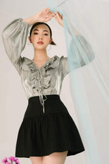 Silk blouse with ruffled neckline and long puff sleeves for elegant day-to-night styling