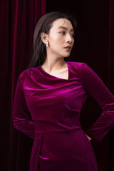 Velvet long-sleeve gown with draped neckline and cinched waist in floor-length silhouette