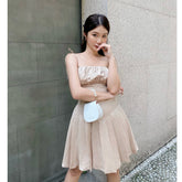Silk mini dress with ruched bust, flared pleated skirt and delicate tie shoulder straps