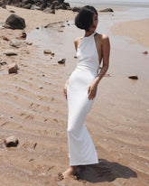 Elegant halter-neck velvet dress with open back and slim silhouette for formal evening occasions