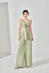 Silk crop top with twist-knot front and spaghetti straps, featuring back smocking detail