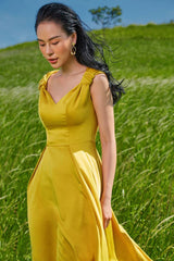 Sleeveless A-line midi dress crafted in smooth silk with soft pleats and romantic shoulder ties