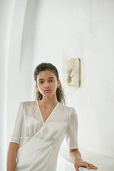 Elegant wrap-style linen blouse with side tie and soft tailored silhouette