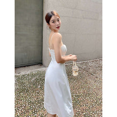 Silk midi dress with ruched bust and adjustable straps, featuring a sleek fitted silhouette