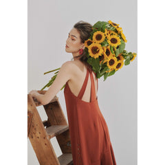 Silk slip dress with flared hem and double-strap open back for a sleek, modern silhouette