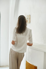 Elegant wrap-style linen blouse with side tie and soft tailored silhouette