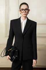 Tailored structured blazer with sharp shoulders and sculpted waist for elevated styling